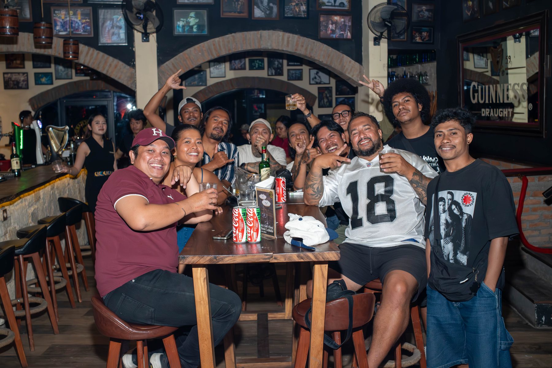 Friends celebrating at the bar at The Orchard